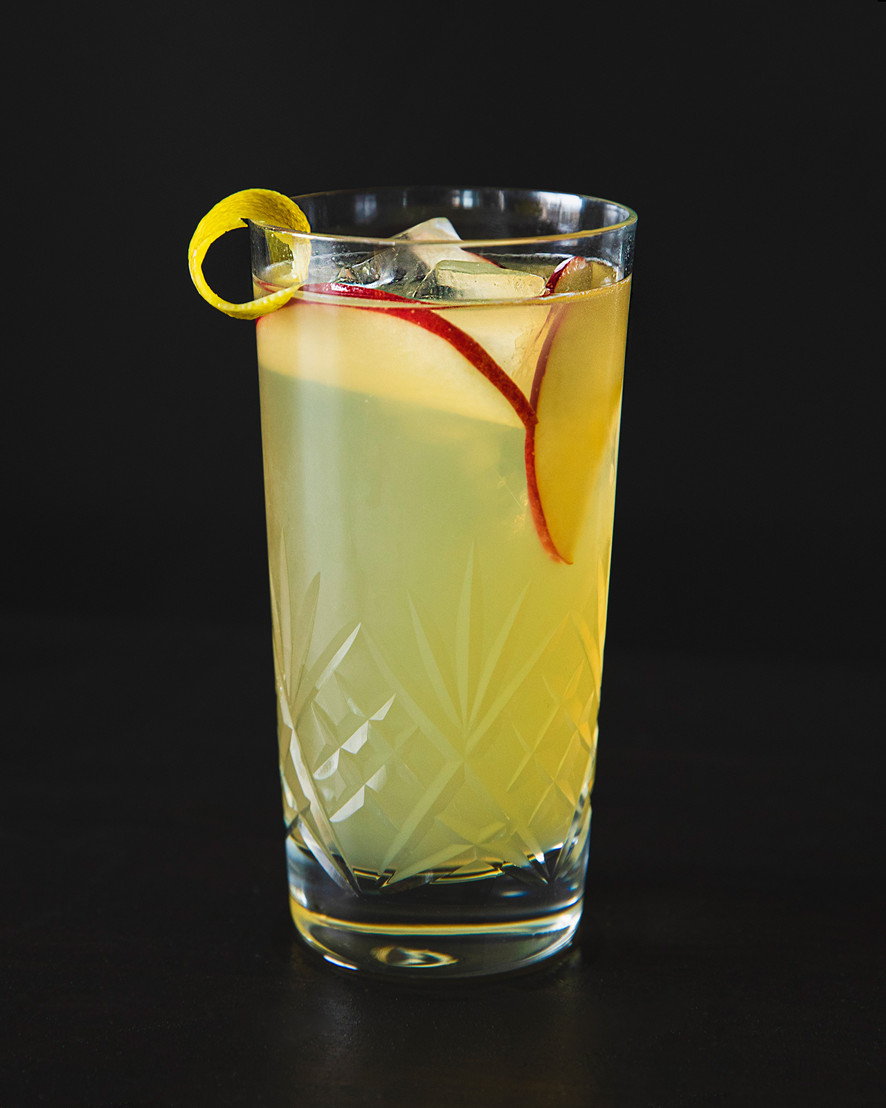 Cocktail Mari-Jo garni de tranches de pomme et d'un zeste de citron